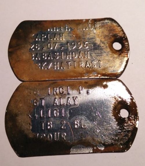Close-up of dog tags caught during magnet fishing